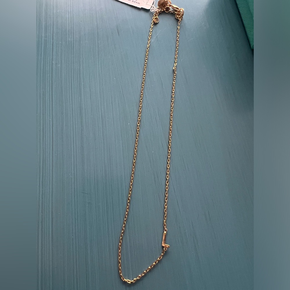 Gold necklace with “L” initial